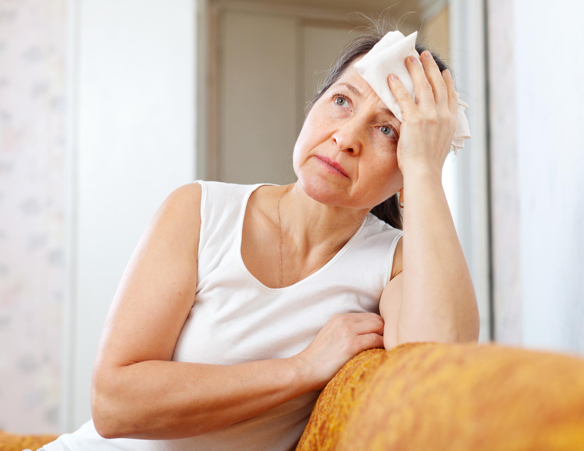 mature woman uses handkerchief on head
