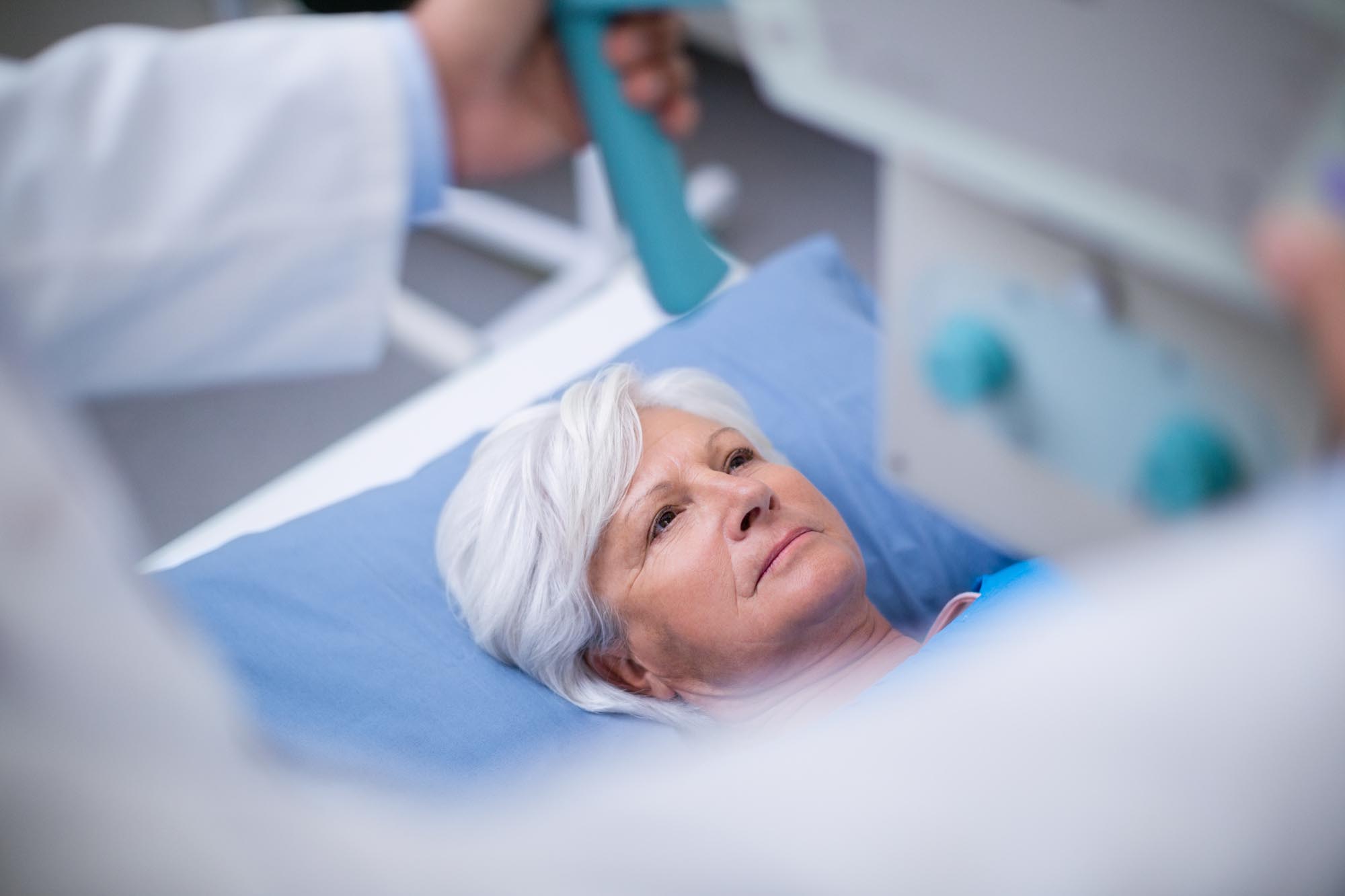 Senior woman undergoing an x-ray test in hospital
